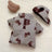 Warm padded dog coat and hat set with lead ring, in a home setting