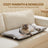 Dog resting on a white thick pet bed mat outdoors