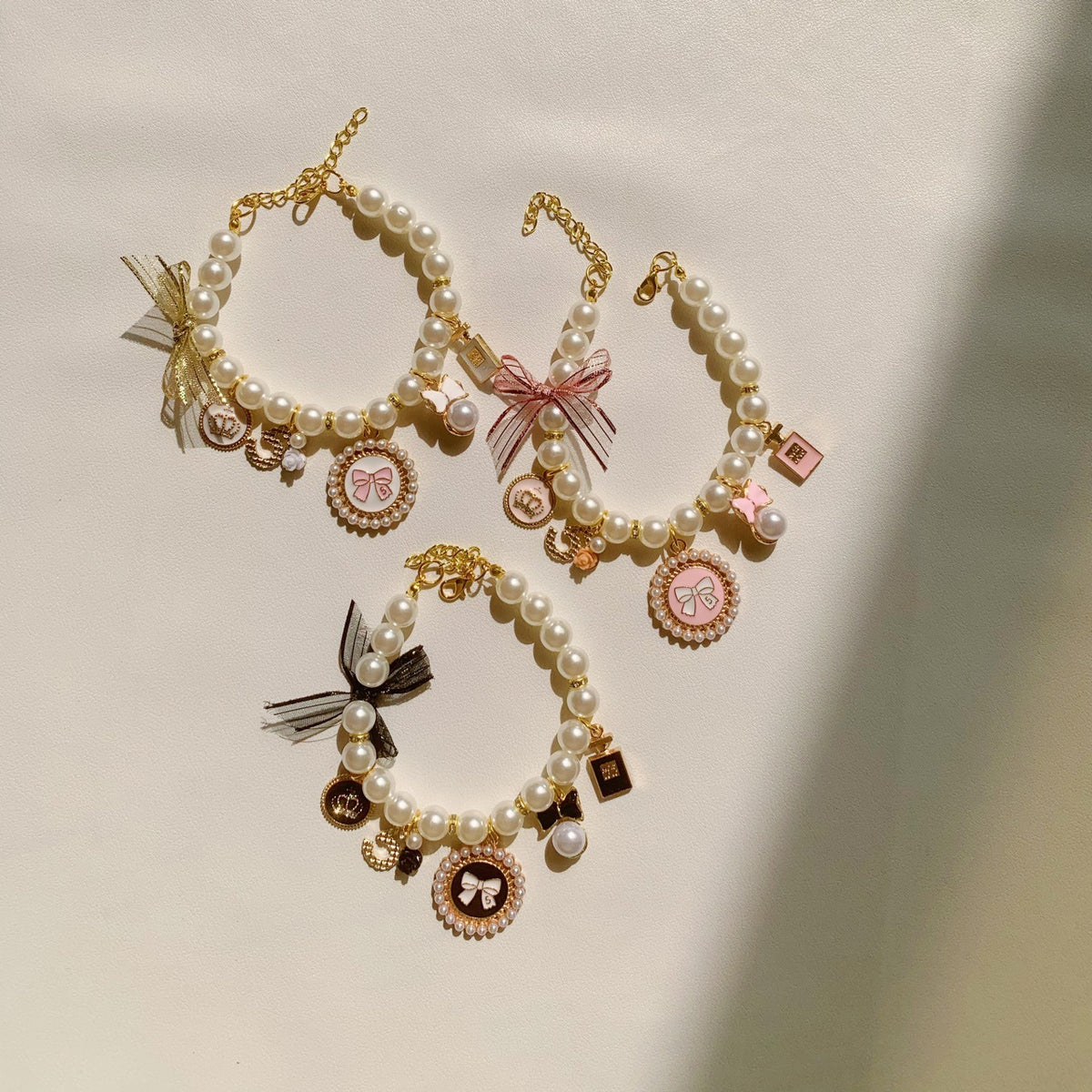 Faux pearl necklace collar with bell in Pink, front view
