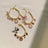 Faux pearl necklace collar with bell in Pink, front view