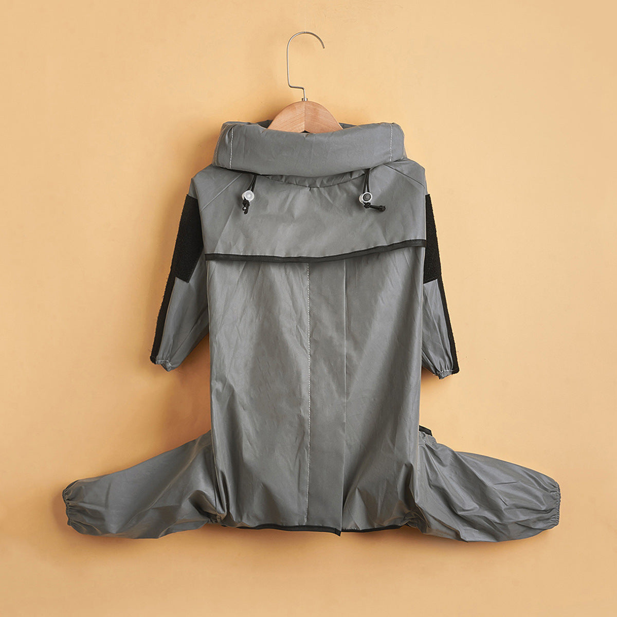 Reflective hooded dog raincoat in silver fabric, in a home setting