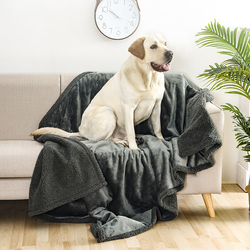 Waterproof double-sided pet blanket in grey on a sofa