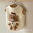 Cotton pet vest with 3D teddy bear pocket in White, in a home setting