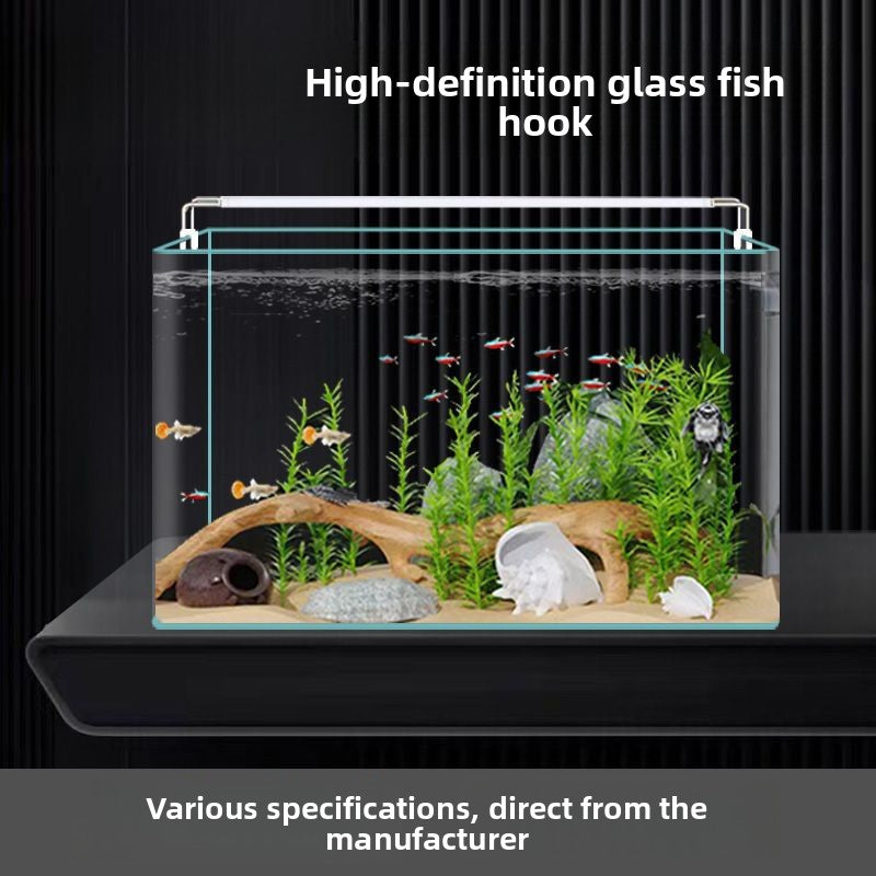 Curved glass goldfish tank on a desk with plants, view 1
