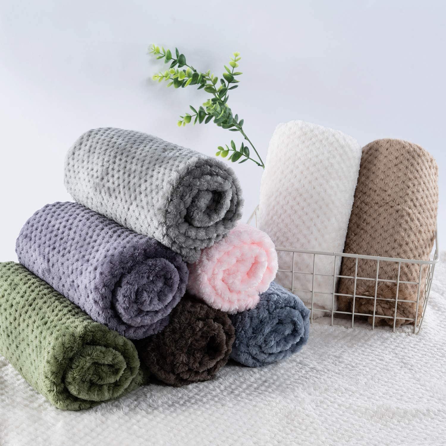 Dusty pink soft pet throw on a sofa