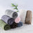 Dusty pink soft pet throw on a sofa