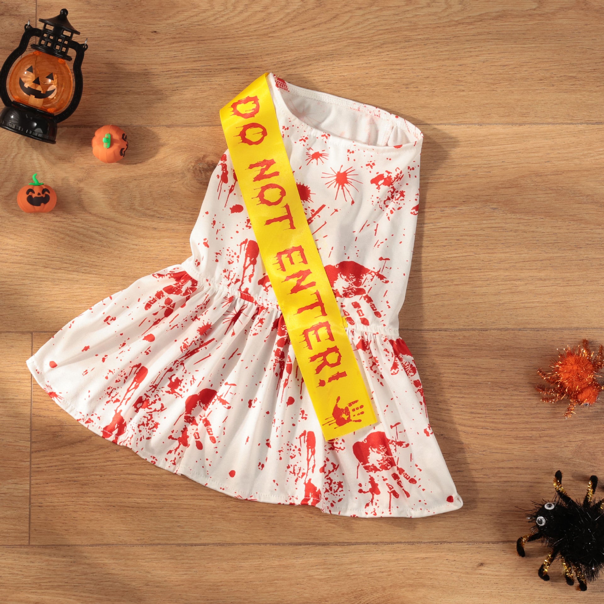 Small dog wearing a blood splatter print Halloween costume