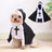 Small dog dressed in a priest Halloween costume
