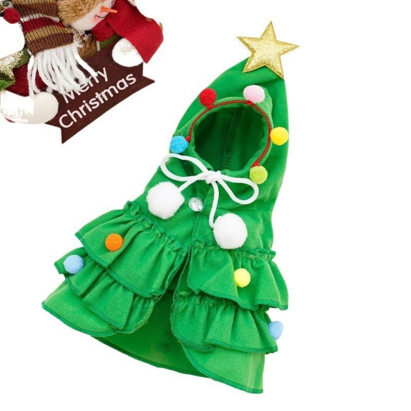 Small dog wearing a green plush Christmas tree cape