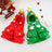 Cat wearing a red Christmas tree pattern cloak