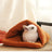 Guinea pig resting in a light grey warm nest