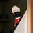 Cat wearing a red and gold robe with a tall hat