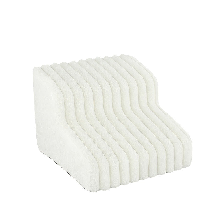 Grey two-step pet stairs placed beside a sofa