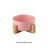 Cat eating from a pink ceramic bowl at home