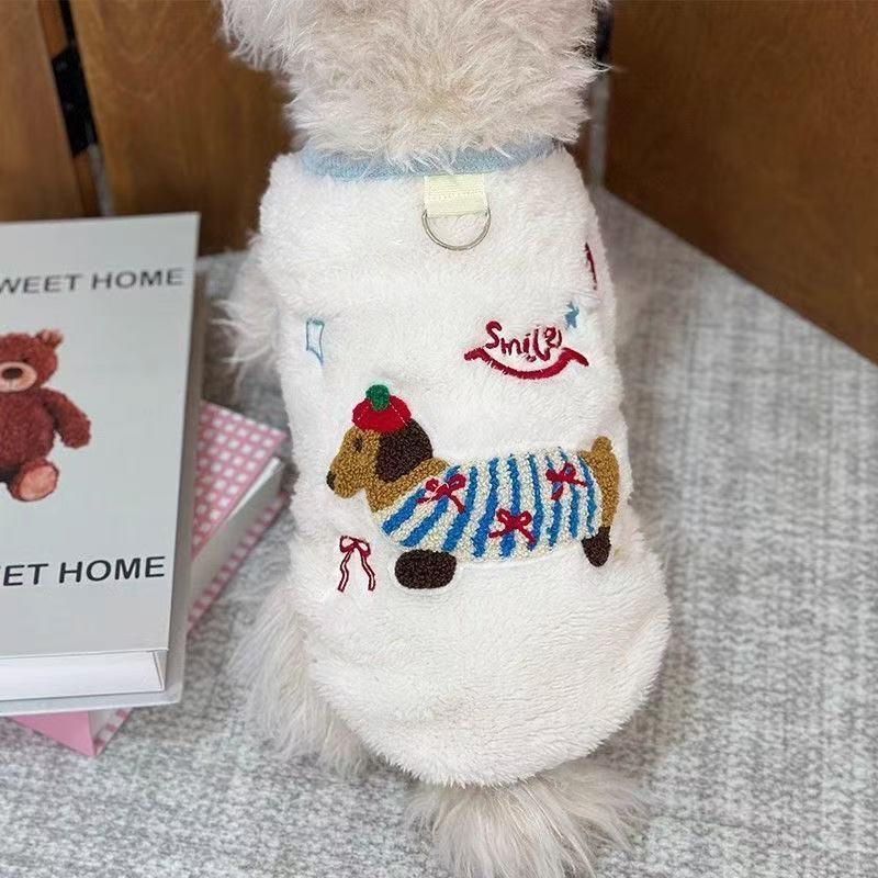 Small dog wearing a pink thick fleece cartoon vest