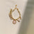 Faux pearl necklace collar with bell in White, in a home setting