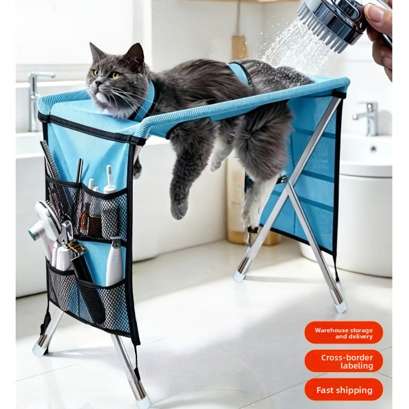 Blue mesh top grooming table holding a small dog during bathing
