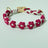 Handmade woven boho pet collar with pearl flowers in Rose Red, in a home setting
