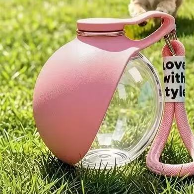 Silicone dog travel water bottle with ball outlet in Blue, in use with a pet