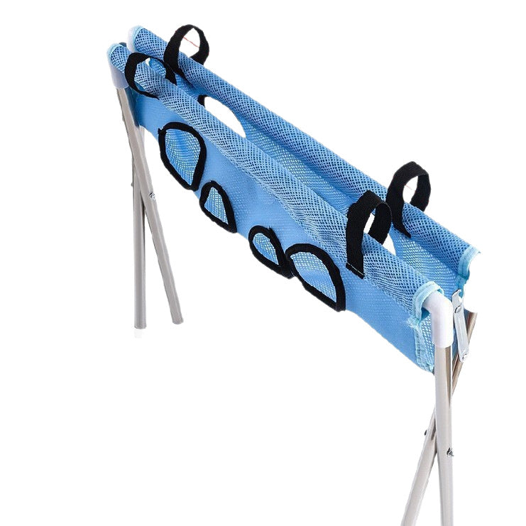 Pet grooming hammock holding a small dog during nail trimming at home