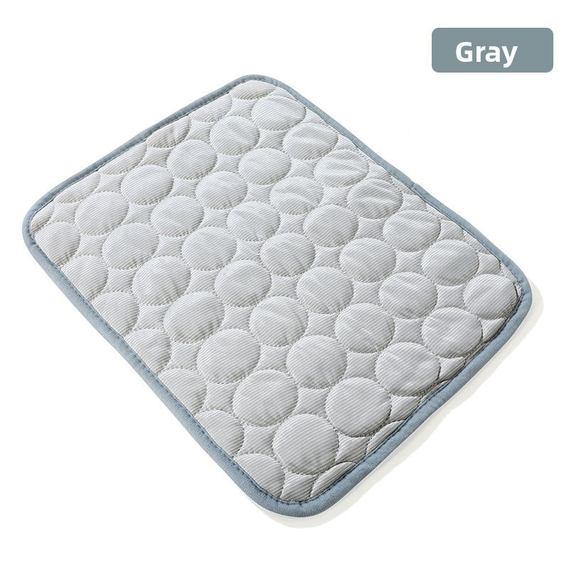 Dog lying on a large grey ice silk mat