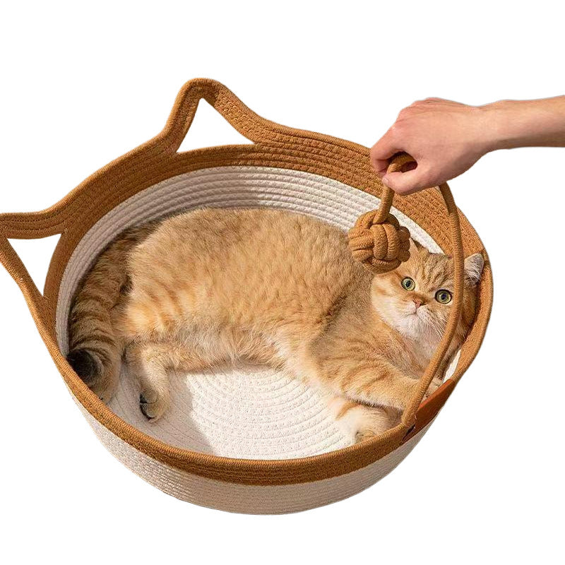 Cat sleeping in a green woven rattan bed with fish pattern pad