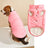 Small dog in a navy padded button up vest