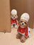 Small dog dressed in a gangster style suit and cape