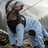 Large dog wearing a blue shark four leg raincoat