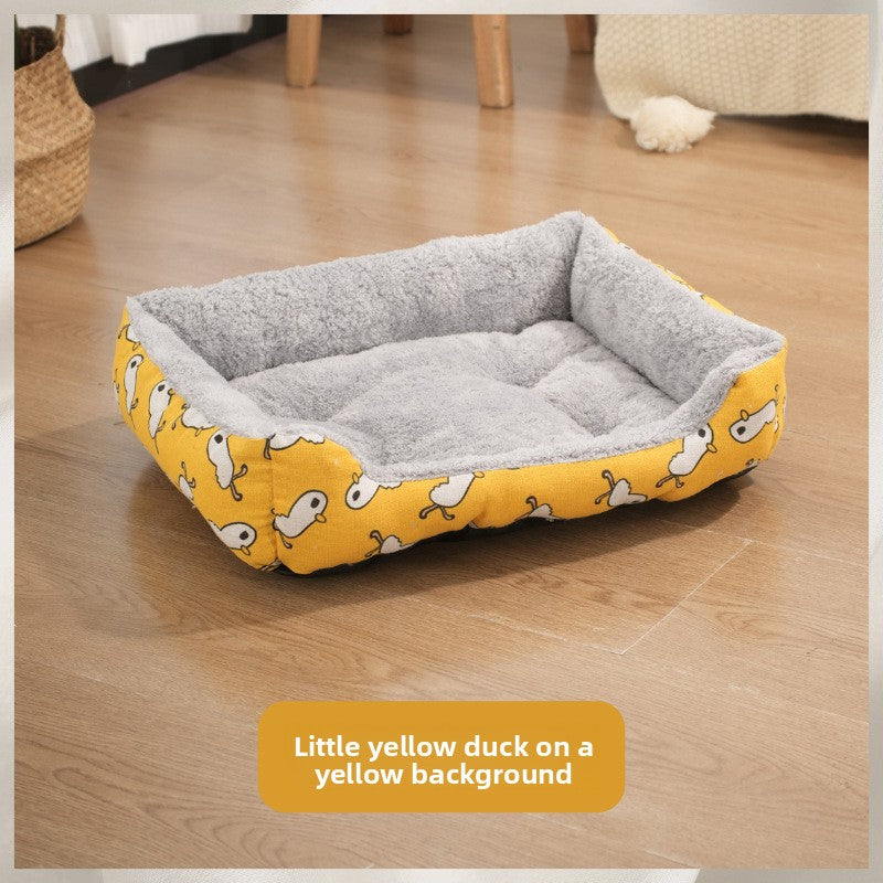 Cat lying on a yellow duck waterproof pet bed mat on the floor