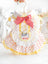 Small dog wearing a pink cotton princess dress