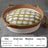 Cat sleeping in a green woven rattan bed with fish pattern pad