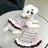 Small dog wearing a bright rainbow striped dress