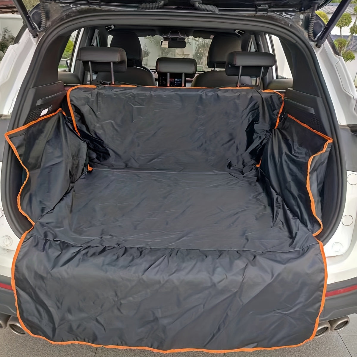 Dog sitting on a black edge boot liner in the car