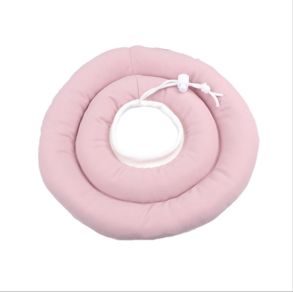 Soft padded recovery cone in light pink on a cat