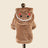 Small dog dressed in a plush gingerbread man costume