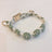 Handmade woven boho pet collar with pearl flowers in Blue, in use with a pet