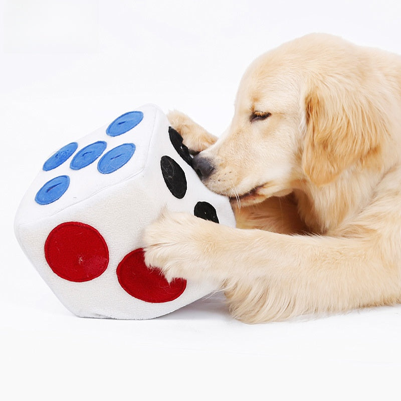 Retriever searching treat hiding pockets in a plush snuffle dice toy