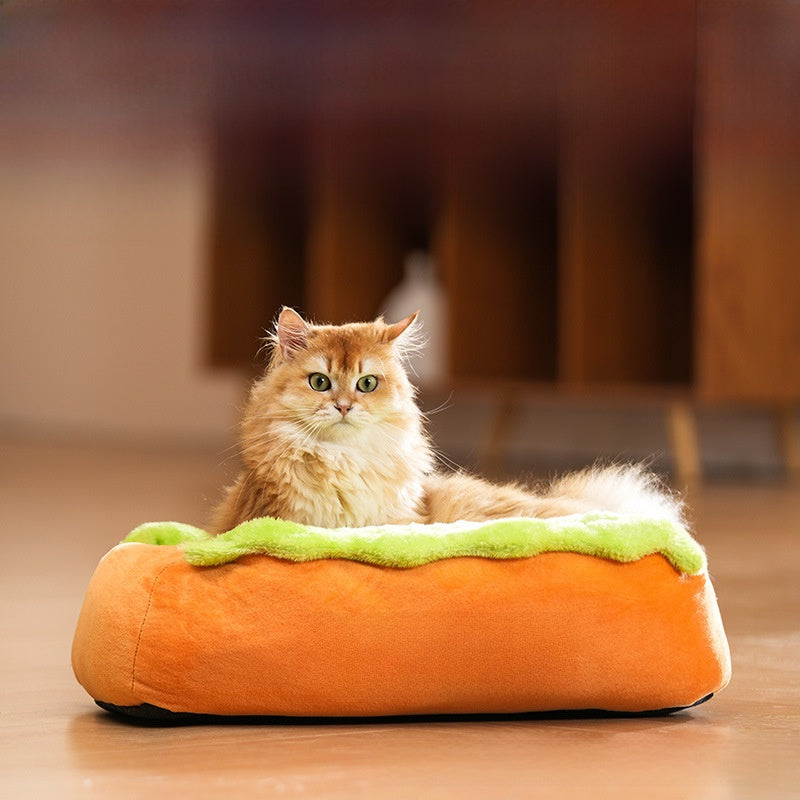 Small dog lying in a cartoon hot dog bed with removable cover