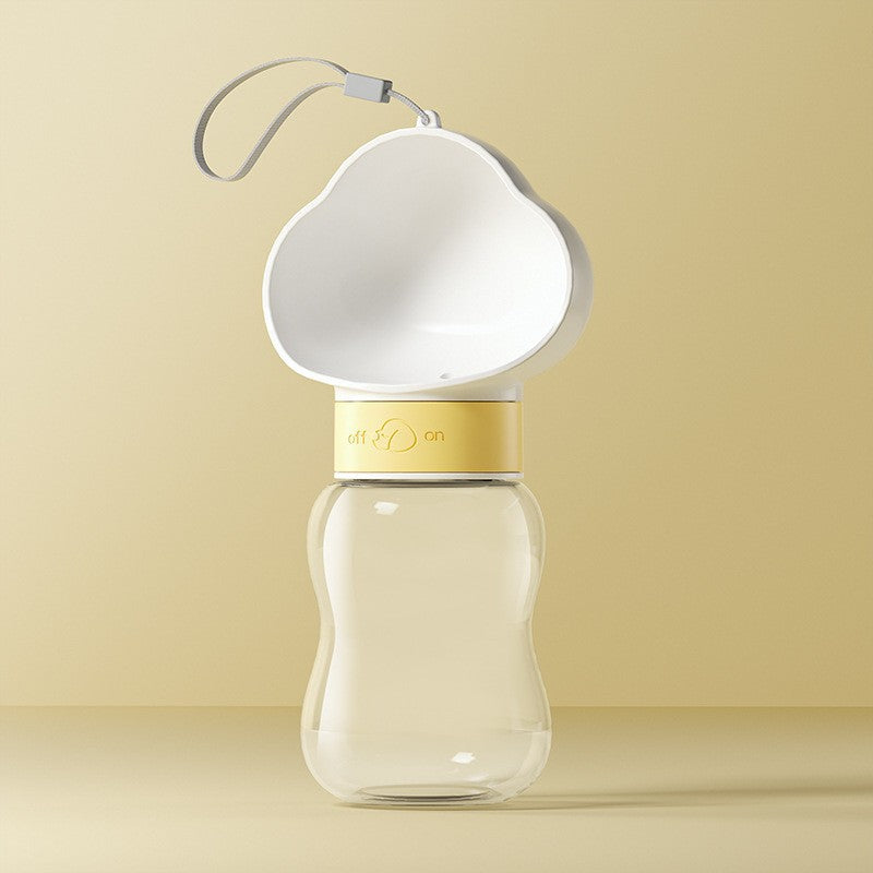 Portable pet water bottle and food container, in use with a pet