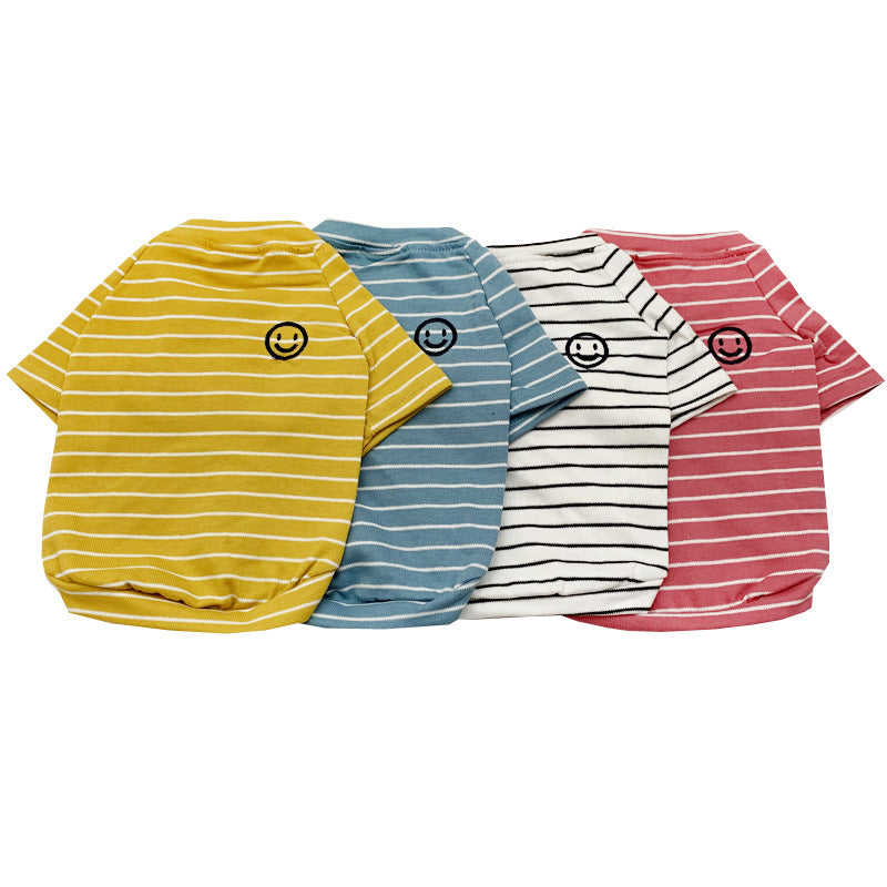 Small dog wearing a striped cotton T-shirt in blue