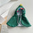 Cat wearing a green Christmas tree costume cloak