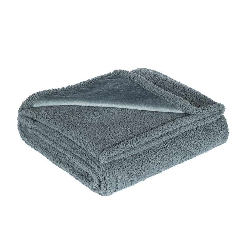 Dog lying on a beige flannel and fleece waterproof throw