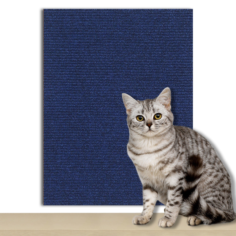 Cat scratching a flocked pad stuck to a wall