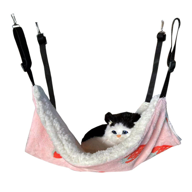 Cat lounging in a strawberry pattern cage hammock