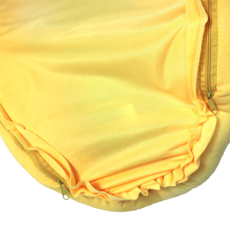 Kitten sleeping in a yellow banana cat bed with heart bone pillow