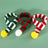 Knitted Christmas pet scarf with red and white festive stripes, view 2