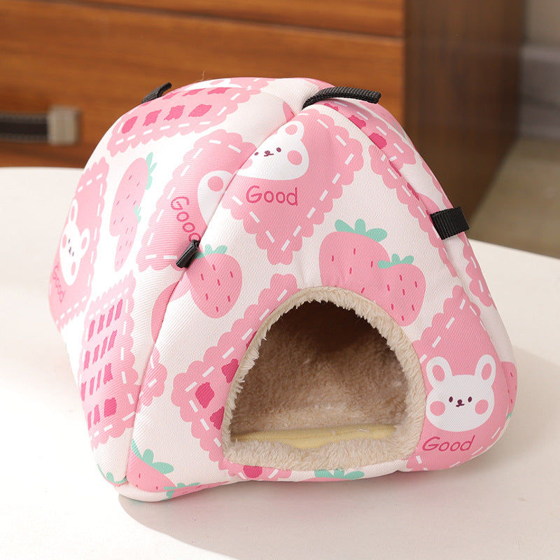 Hamster peeking out of a pink strawberry rabbit nest