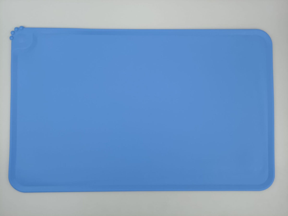 Royal blue non-slip food mat under a dog bowl
