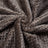 Dusty pink soft pet throw on a sofa